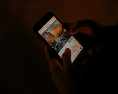 Close up of a smartphone screen being used at evening time